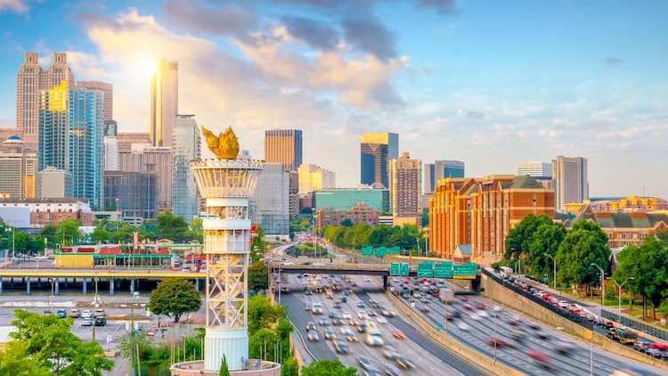 a view of the olympic torch with atlanta in the backdrop