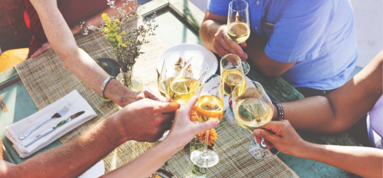 A group of people toasting their drinks