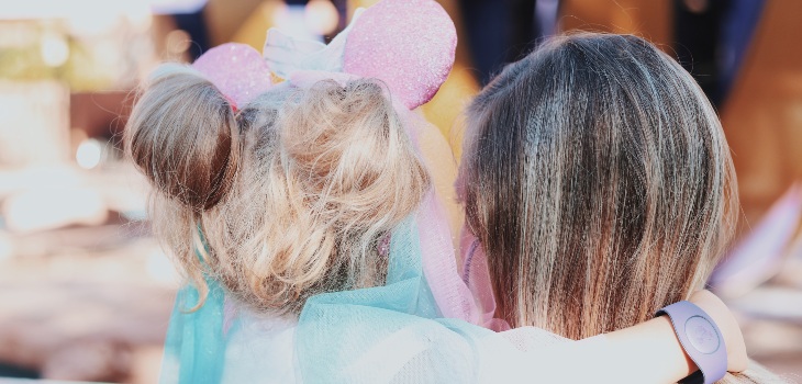 A woman and a child embracing each other at Walt Disney World