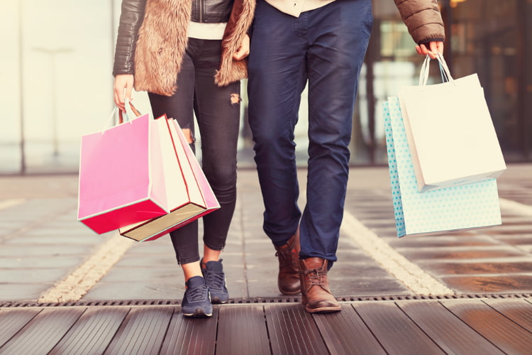 A couple, walking with shopping bags